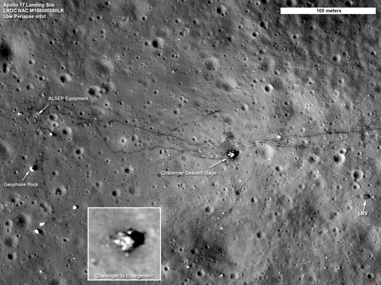 Overhead view from lunar orbit of the Apollo 17 landing site, showing the lander's descent stage, the parked rover and dark rover tracks
